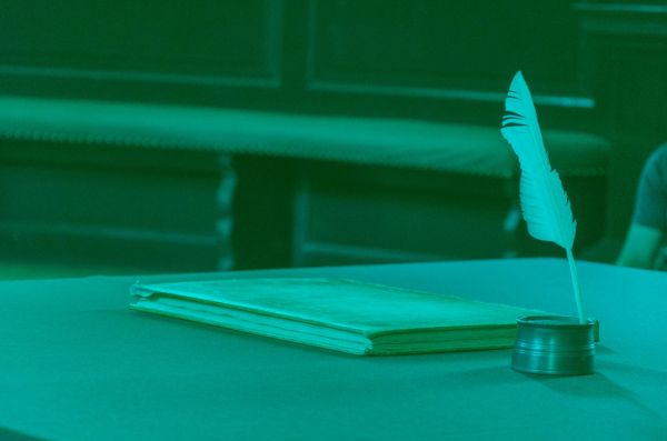 image showing a writing book and a quill