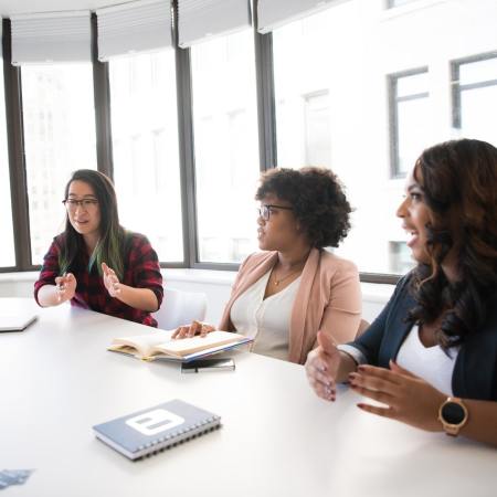 Photo of a group of women in a business meeting.