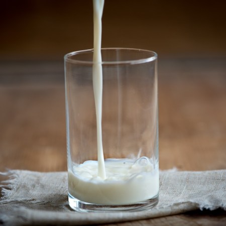 A photo of milk pouring into a glass.