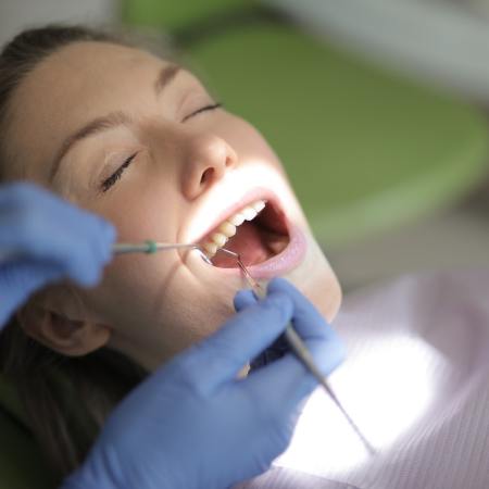 Photograph of a woman at the dentist.
