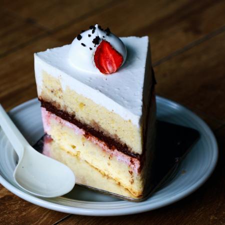 Photograph of a slice of cream cake.