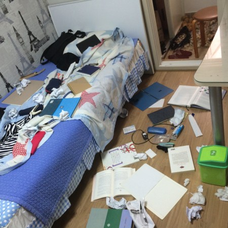 Photograph of an untidy bedroom.