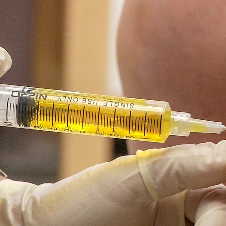 photograph of somebody being injected in the arm