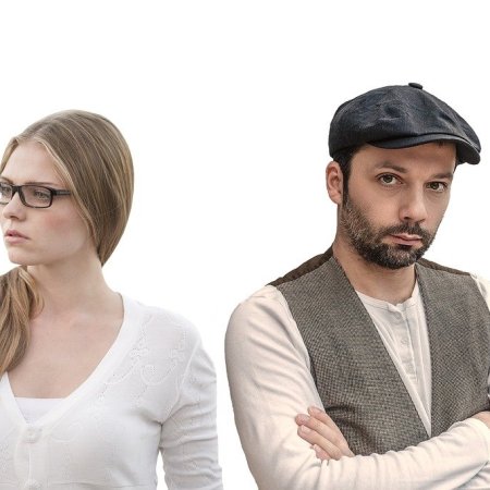 A man and woman standing together. Presumably an unhappy couple, he is looking one way, and she another.