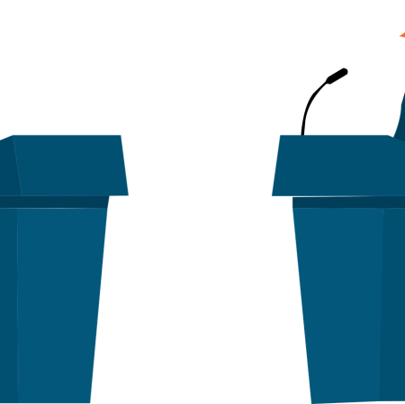 Two politicians, each standing at a lecturn, in a debate with each other.